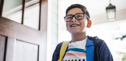 young boy entering a home