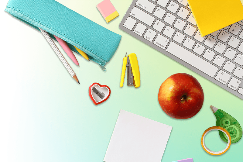 Composite of school supplies (pencils, pencil sharpener, stapler, eraser, etc.) and a keyboard.