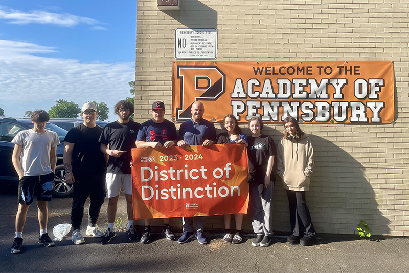 Group of students holding Imagine Nation Award winner banner.