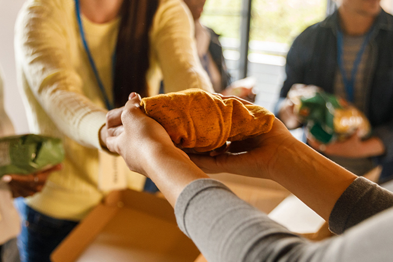 A team of selfless volunteers attentively organizes clothing donations, ensuring that each item is clean and ready to bring warmth to someone's life.