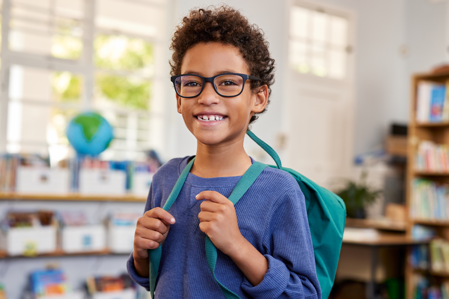 Smiling young student in classroom.